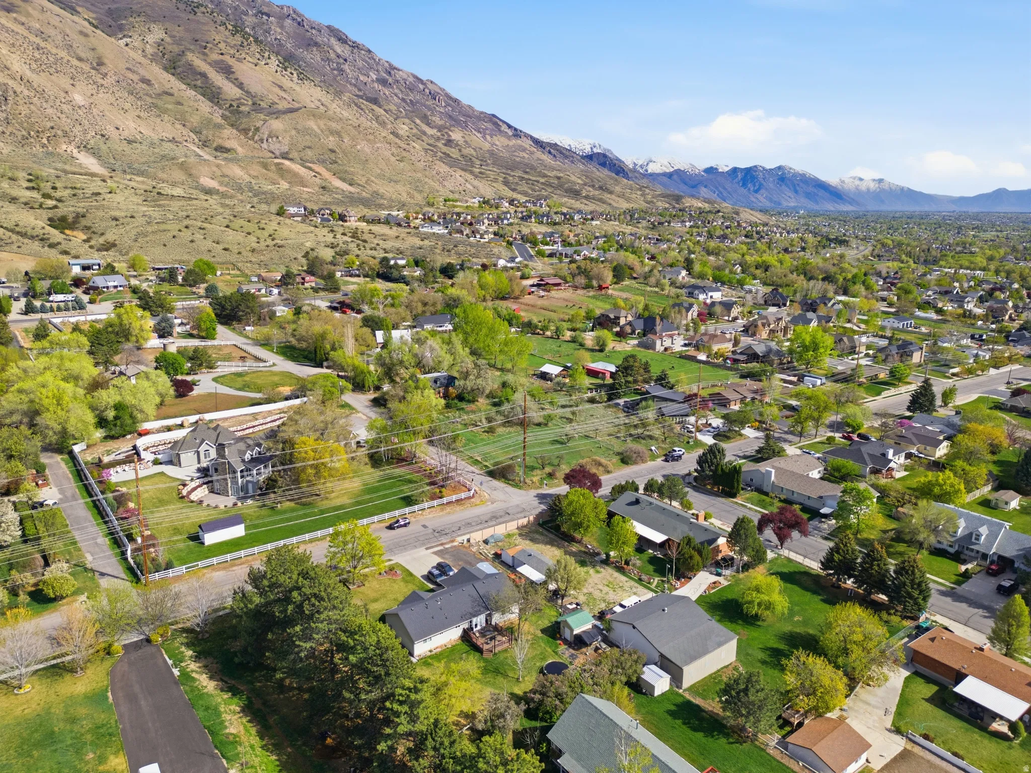 Aerial perspective of suburban property featuring a mountainous background