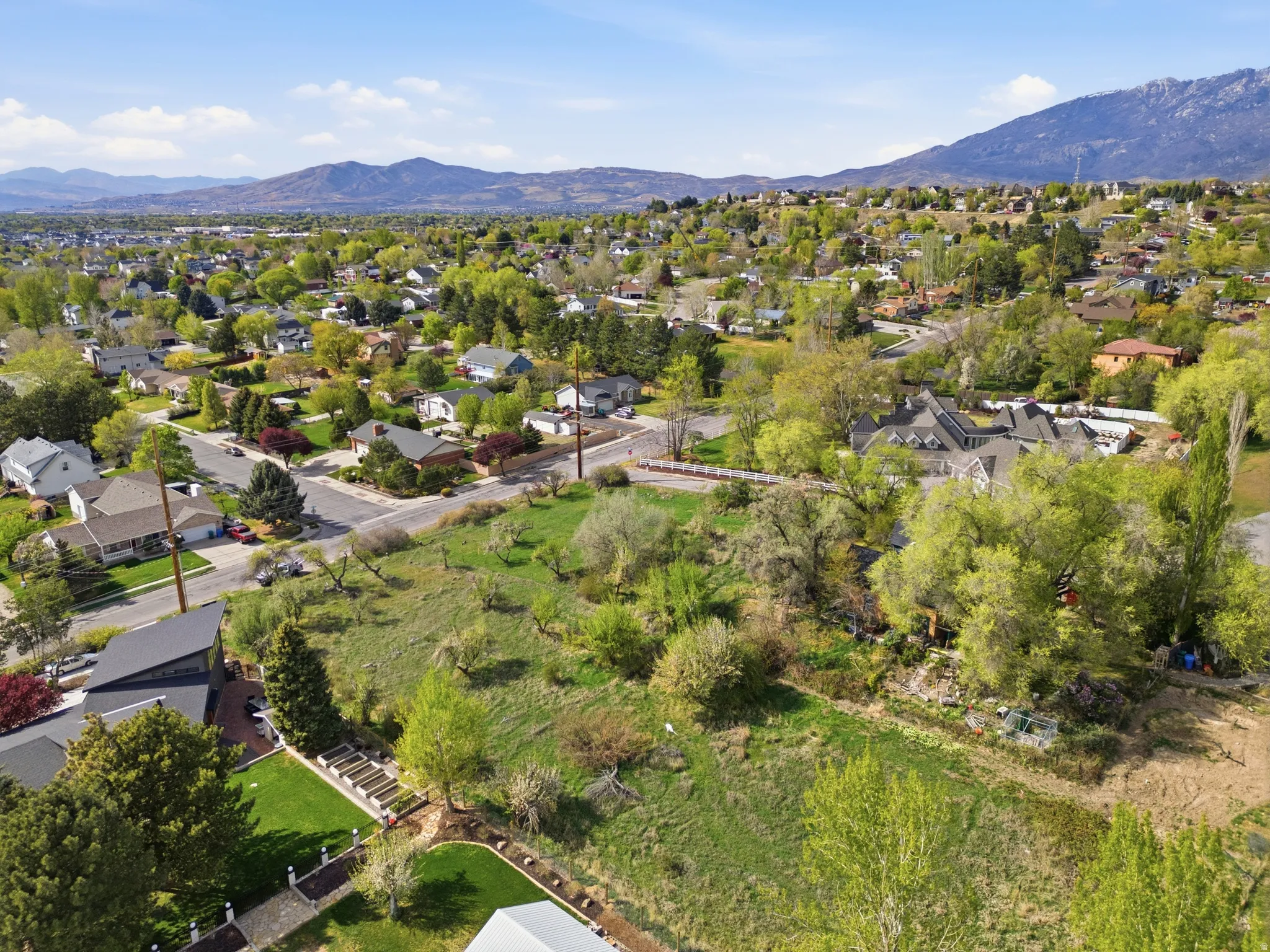 Aerial perspective of suburban property with a mountain backdrop