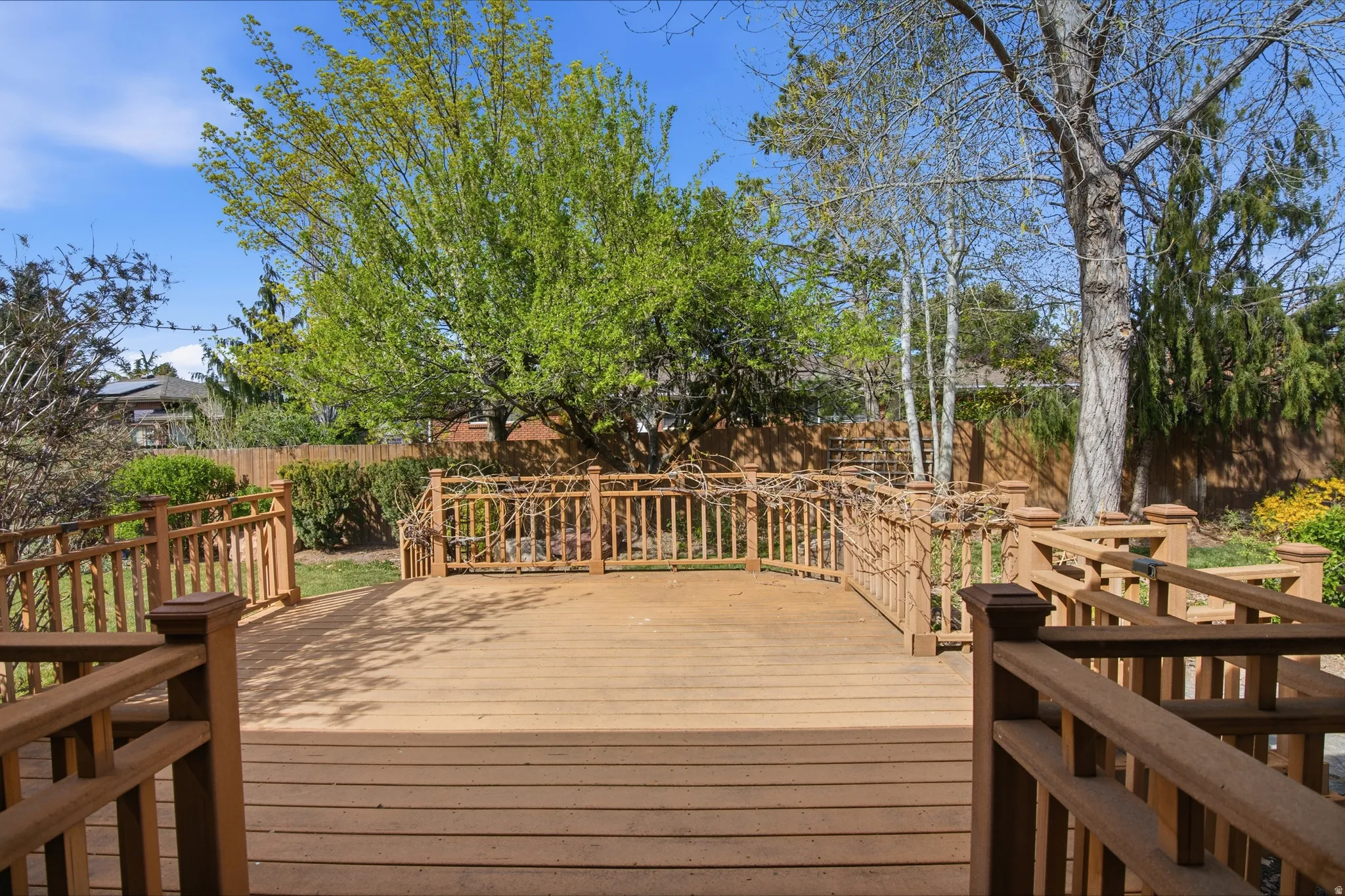 Wooden deck featuring a fenced backyard