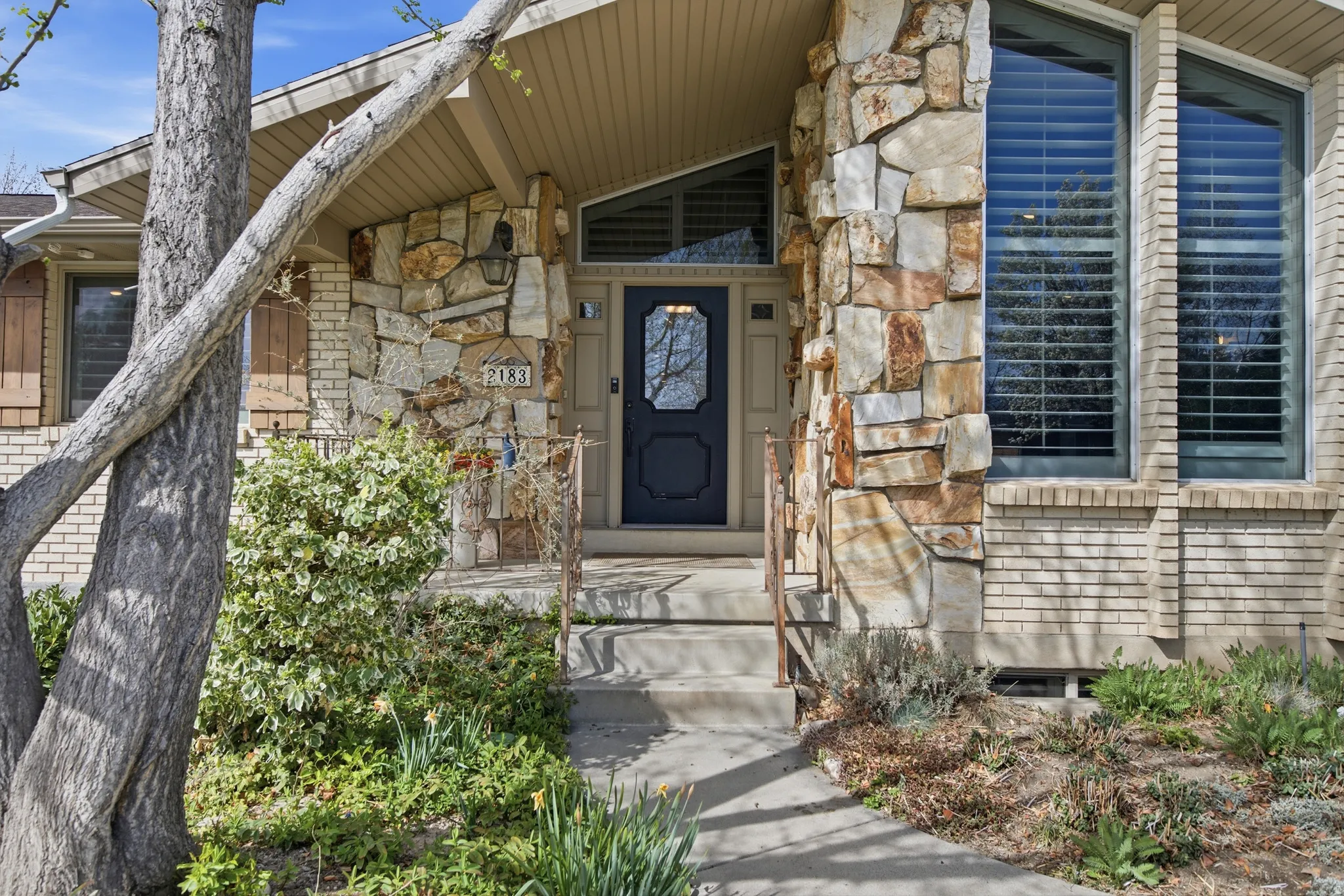 Doorway to property with stone siding