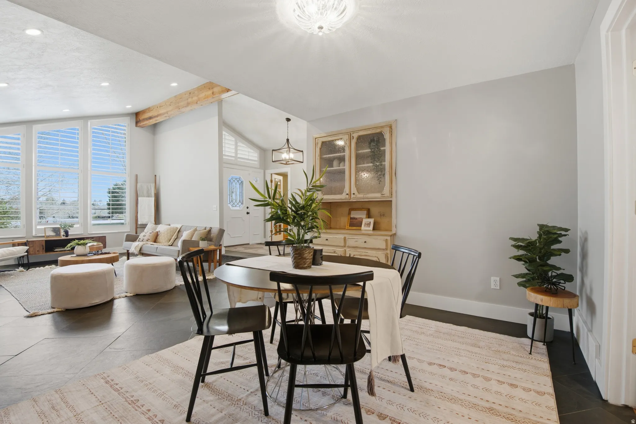 Dining space with vaulted ceiling and recessed lighting
