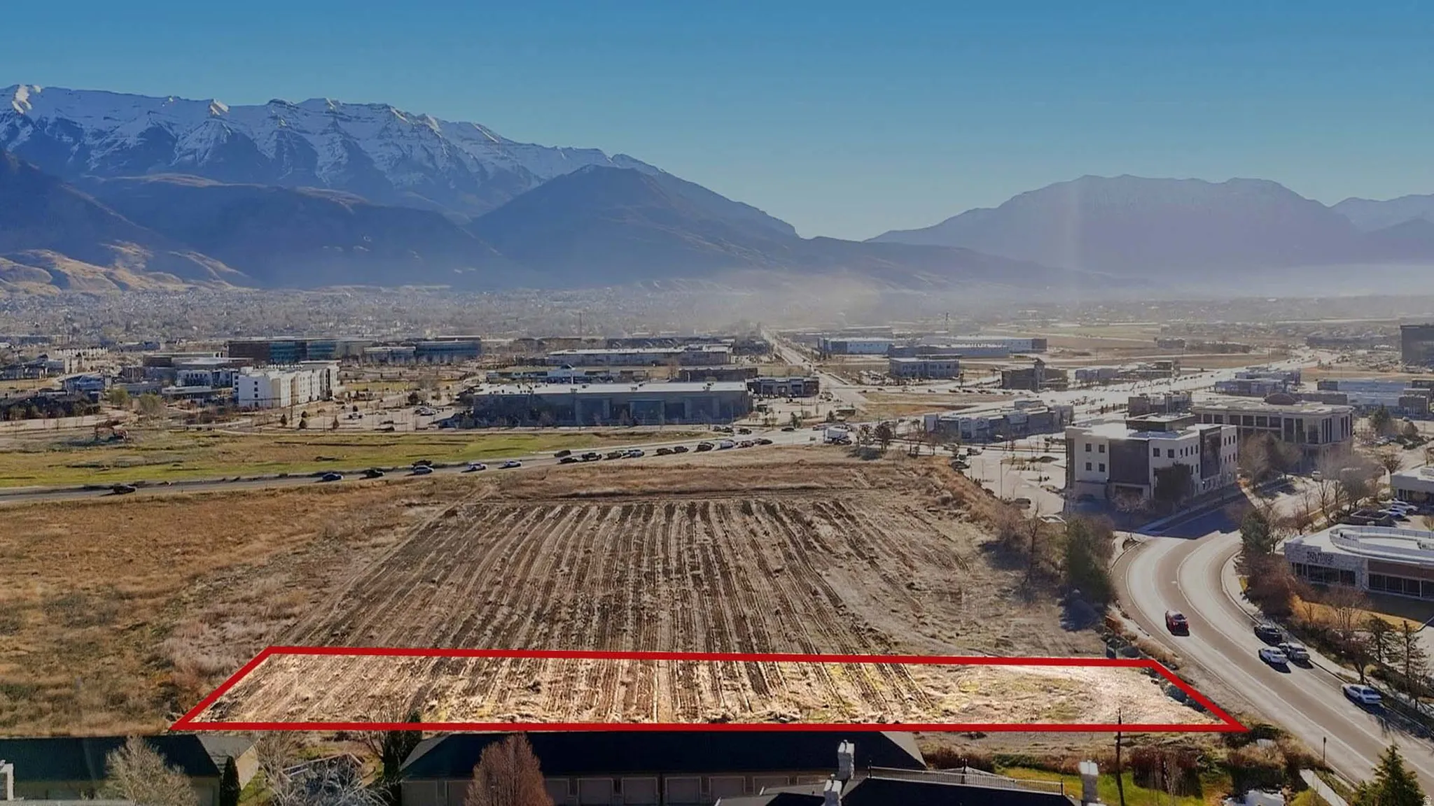 Overview of rural landscape with property parcel outlined and a mountain backdrop. Facing East