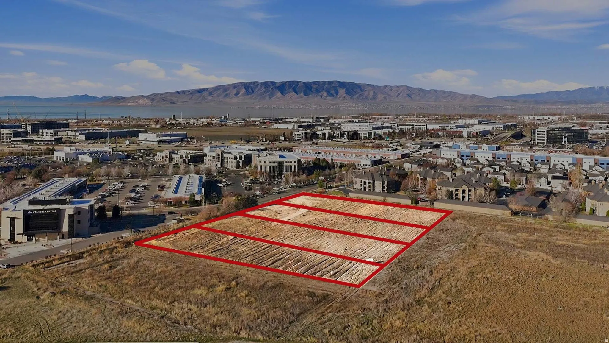 Aerial overview of property's location featuring property parcel outlined and mountains. Facing Southwest