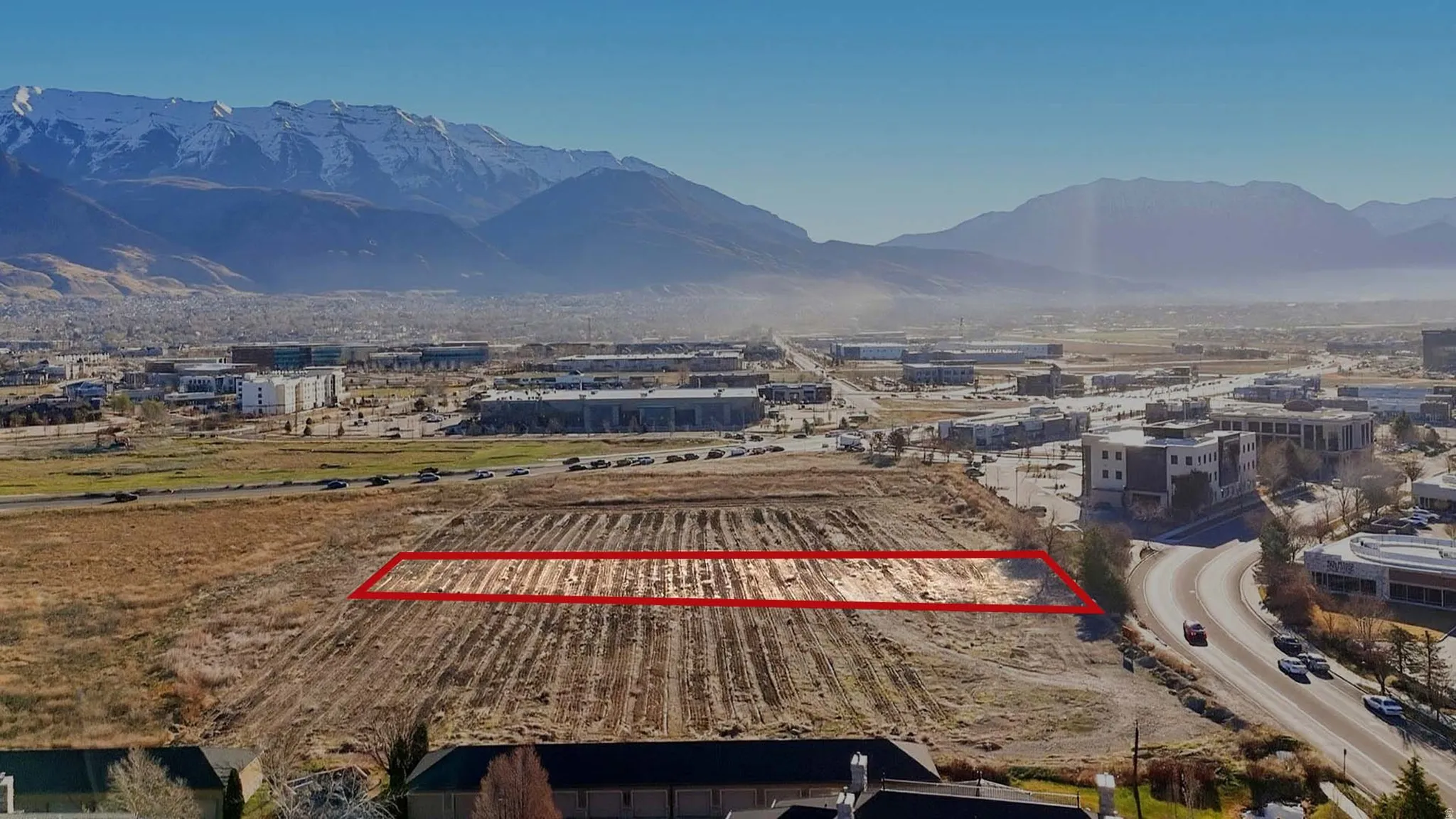 Overview of rural landscape featuring property boundaries highlighted and a mountain backdrop. Facing Southeast