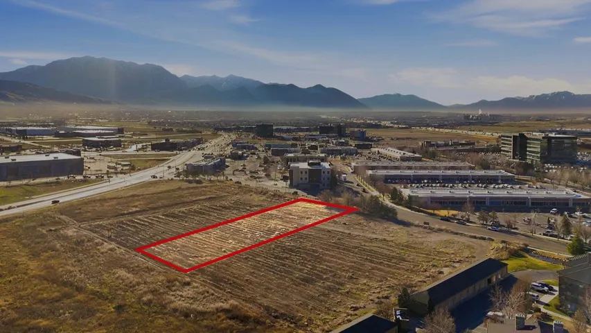 Aerial view of property's location featuring property boundaries highlighted and a mountainous background. Facing South