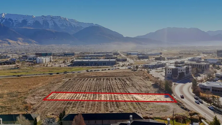 Overview of rural landscape with property parcel outlined and mountains