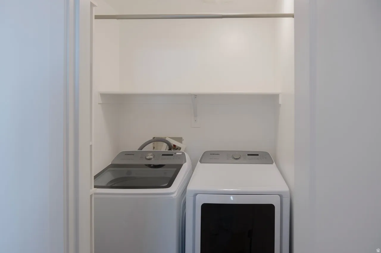 Laundry room with washer and clothes dryer