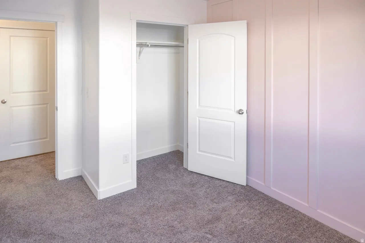 Unfurnished bedroom with carpet and a closet