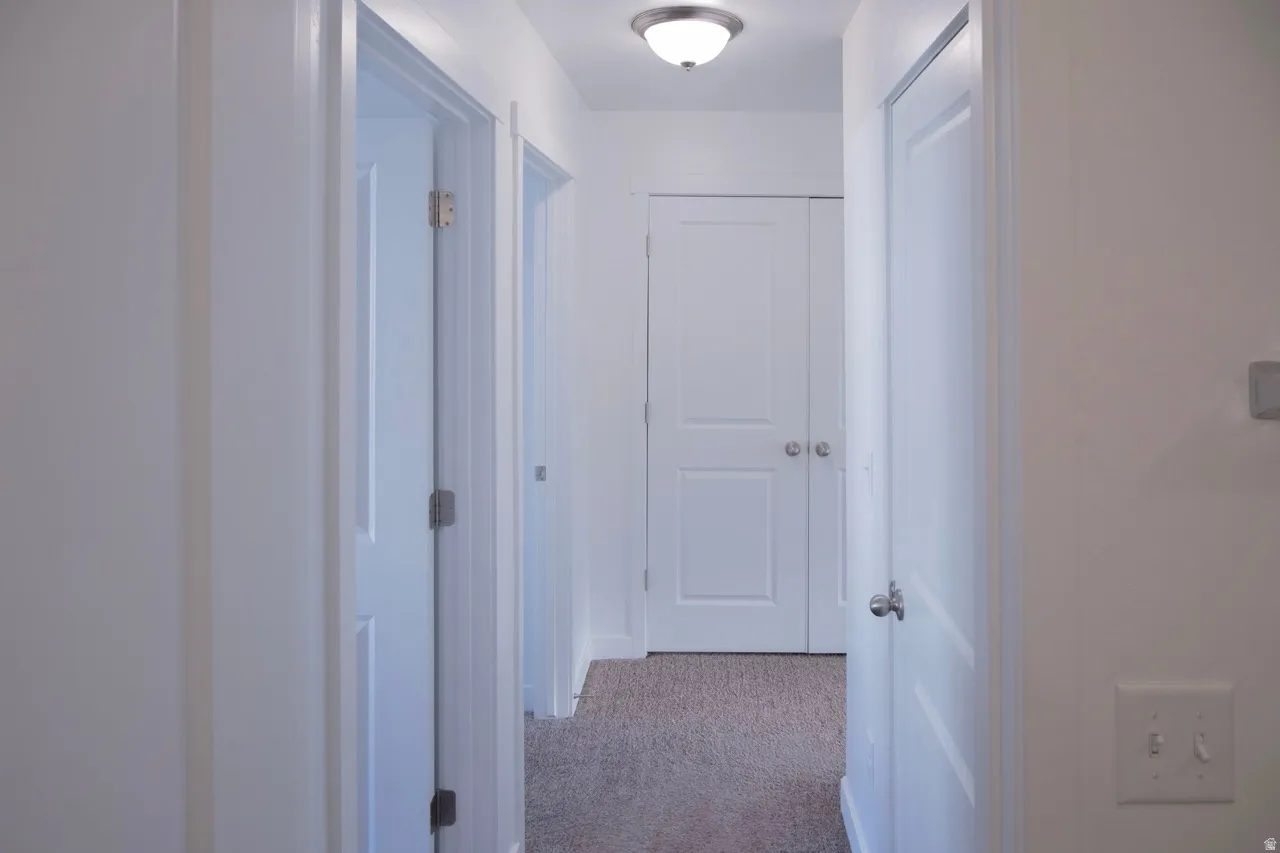 Corridor with light colored carpet