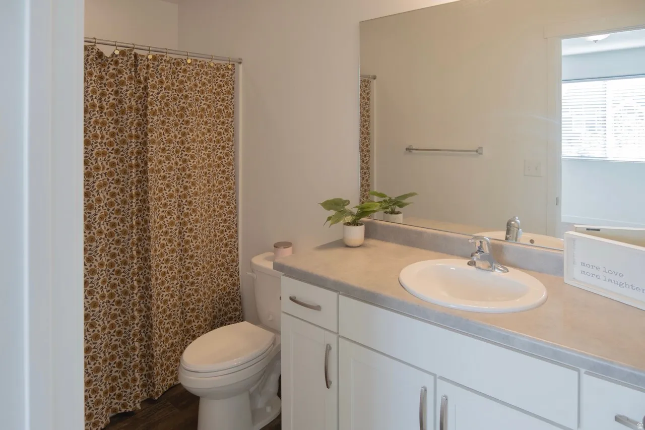 Full bath with a shower with shower curtain and vanity