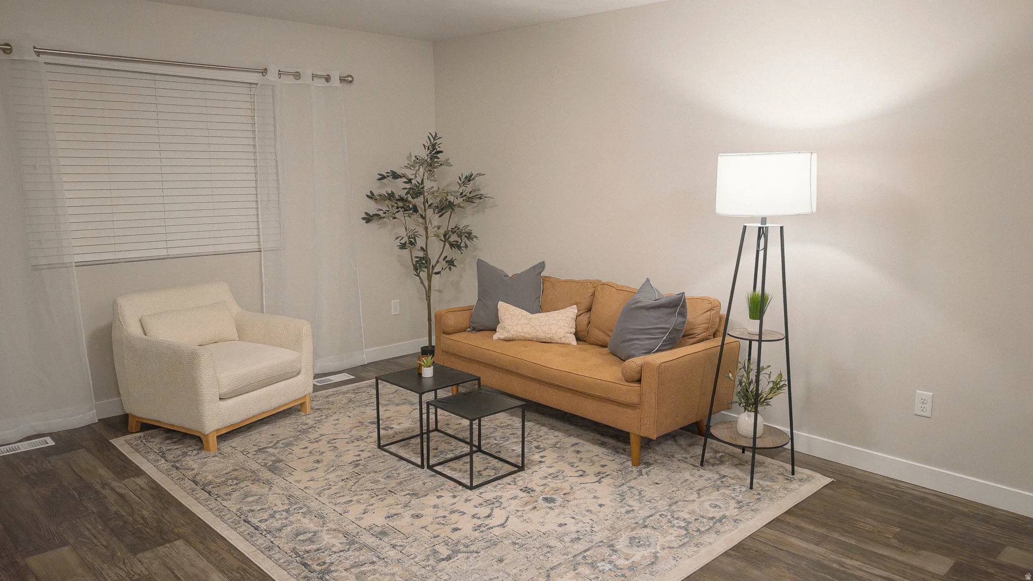 Living area featuring baseboards and dark wood-type flooring