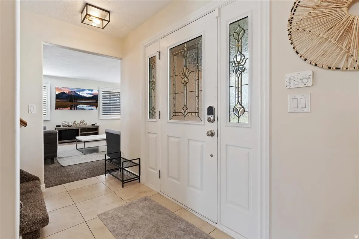 Entryway with light tile patterned flooring