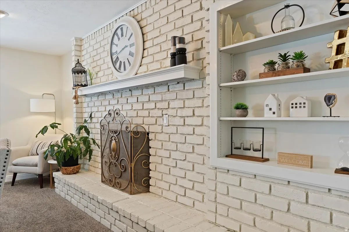 Detailed view of a fireplace and carpet floors