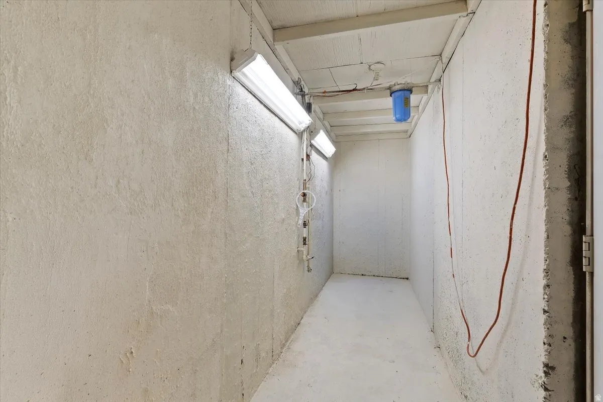 Hall featuring unfinished concrete flooring