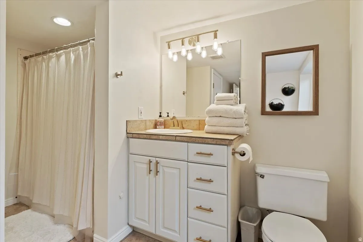 Bathroom featuring vanity and curtained shower