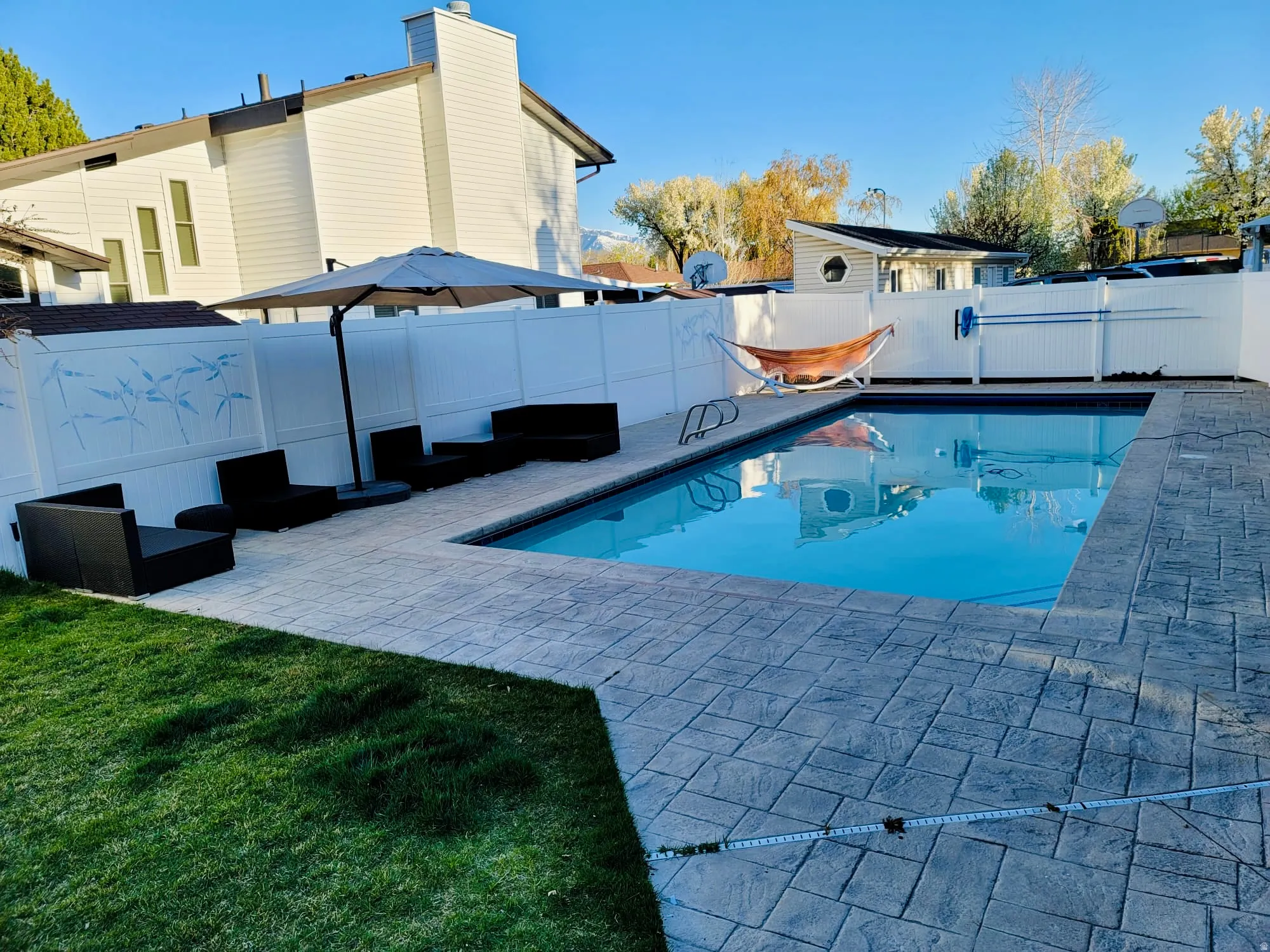 View of pool with patio surround and a fenced backyard