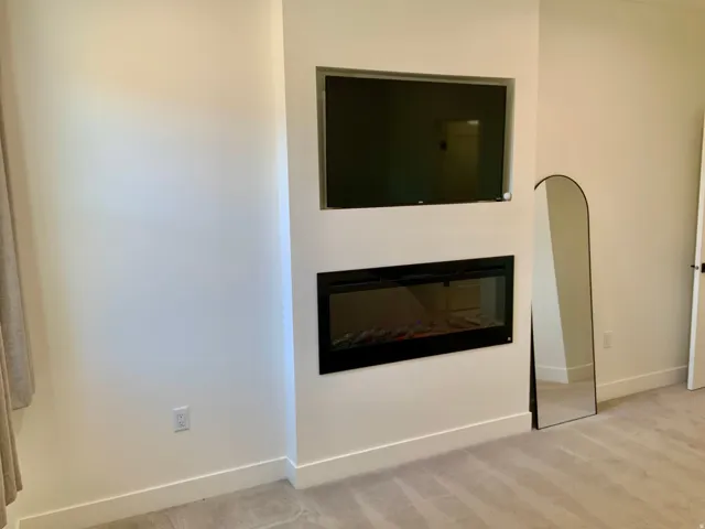 Detailed view of a glass covered fireplace and carpet floors