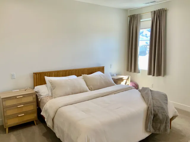 Carpeted bedroom featuring baseboards