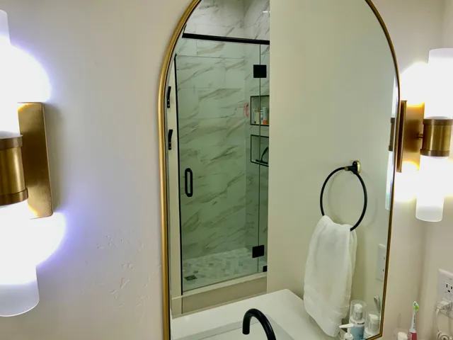 Bathroom with a marble finish shower