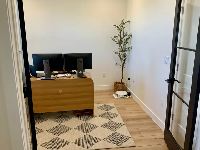Home office with light wood-style floors and baseboards