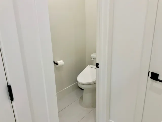 Bathroom with baseboards and light tile patterned flooring