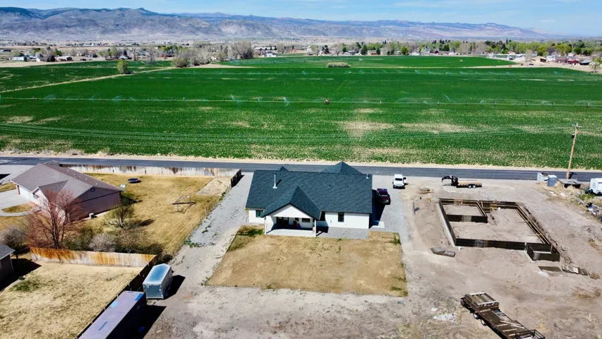 Aerial view of property and surrounding area featuring mountains