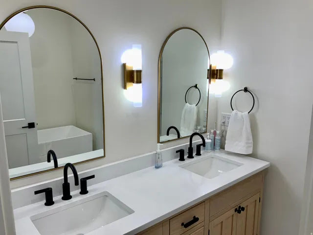 Full bathroom with double vanity and a soaking tub