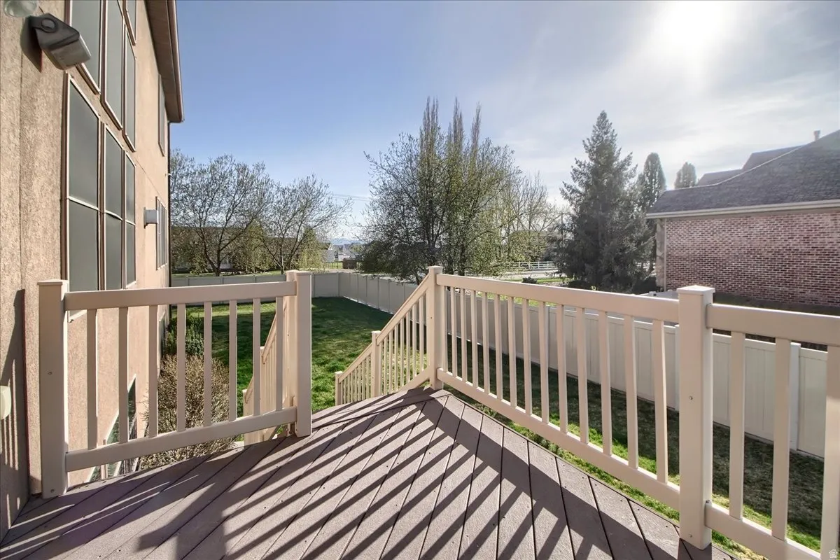 Wooden deck with a fenced backyard