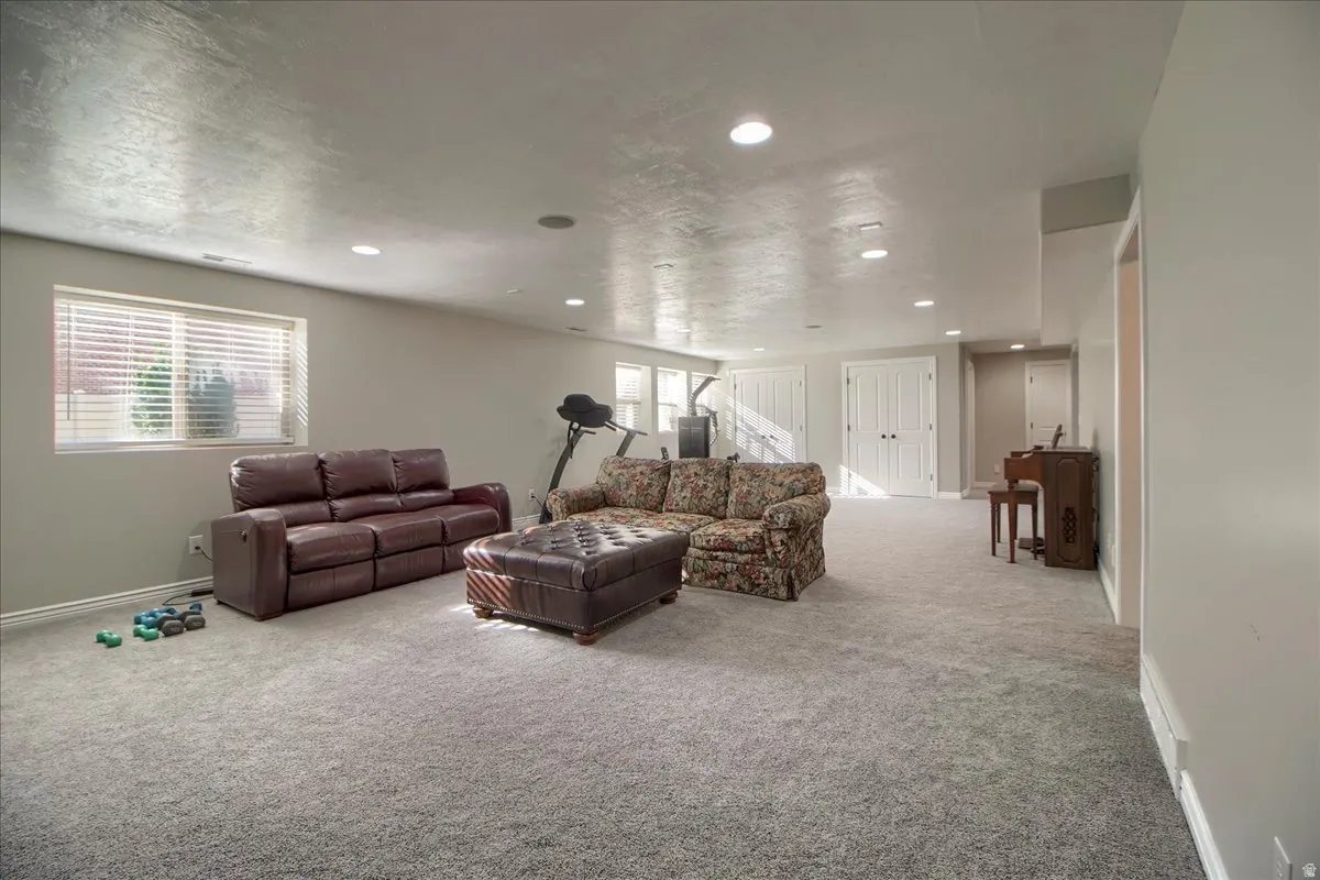 Carpeted living area with recessed lighting