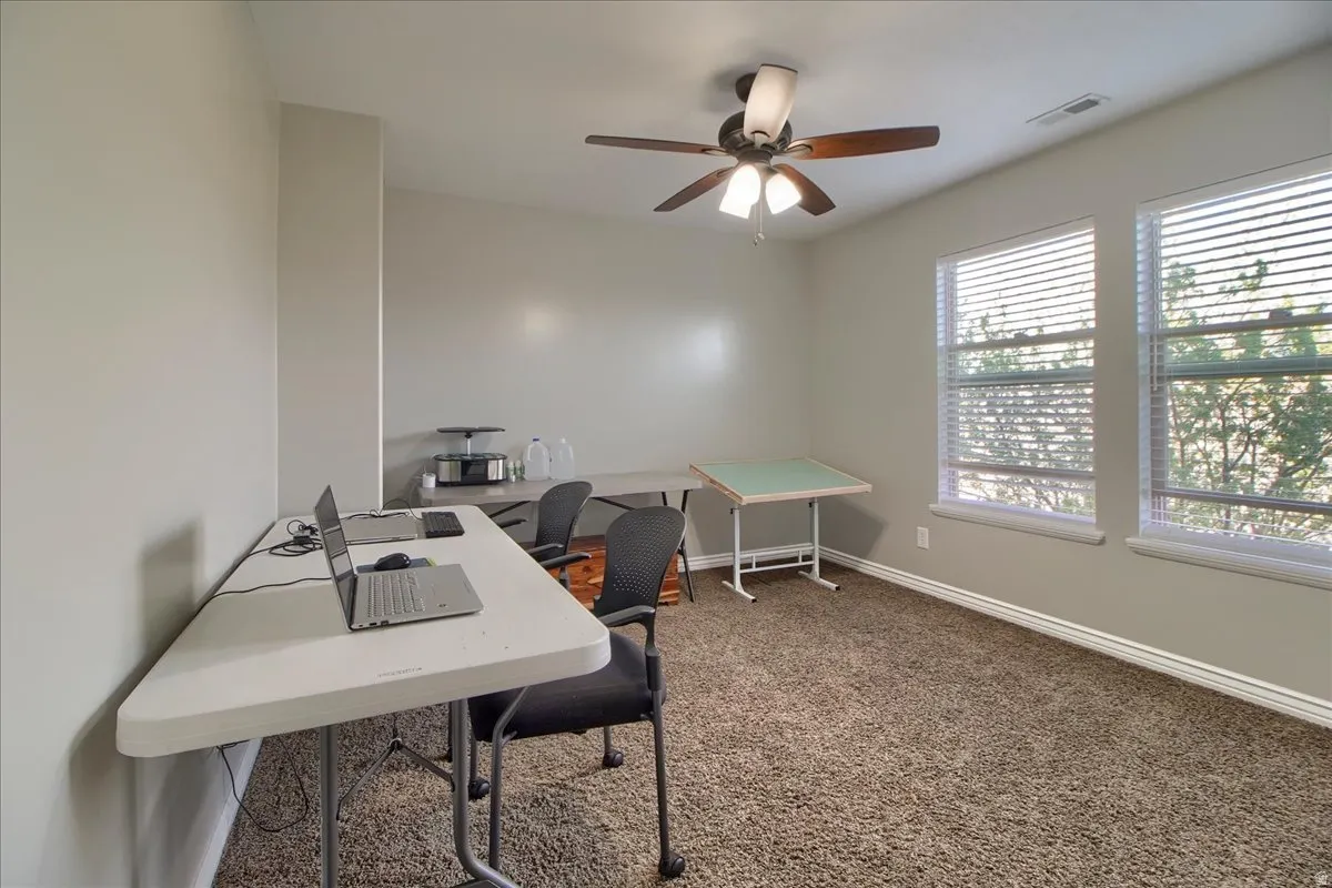 Office space featuring ceiling fan and carpet floors