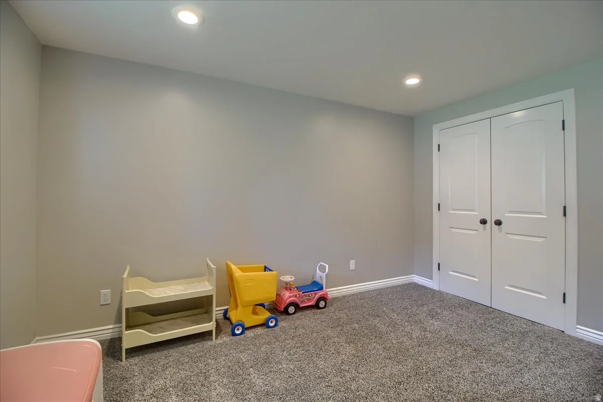 Game room with carpet flooring and recessed lighting