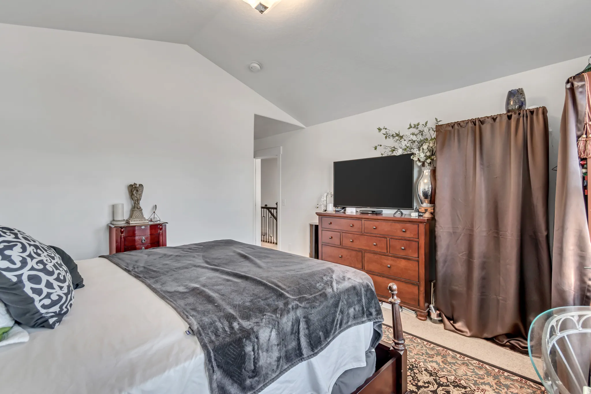 Bedroom with lofted ceiling and carpet