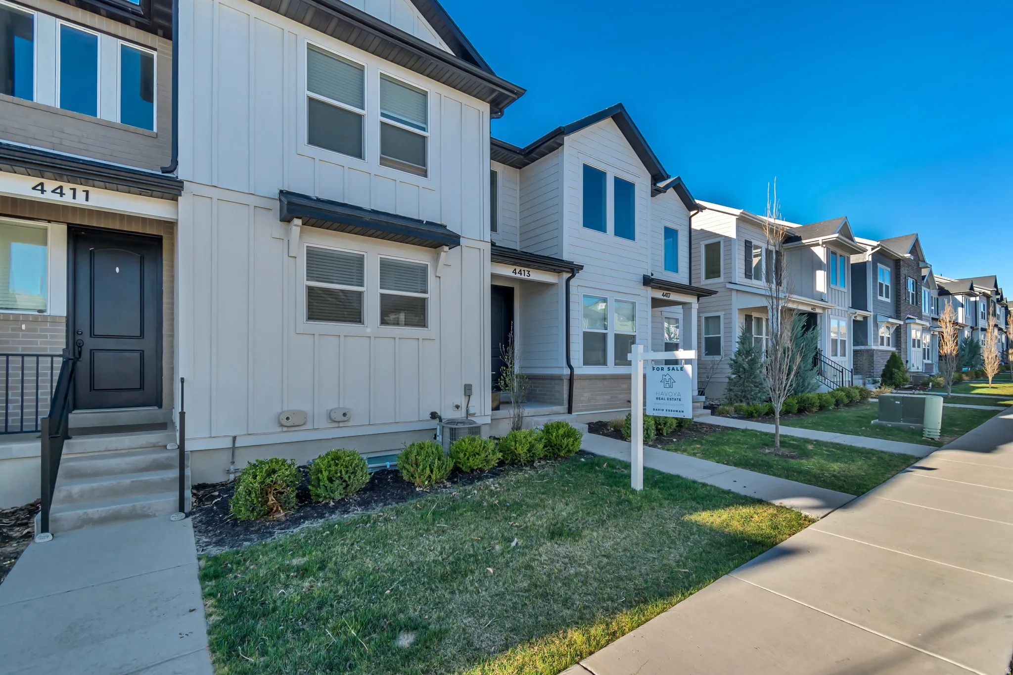 View of front of home featuring board and batten siding, a residential view, a front yard, and entry steps