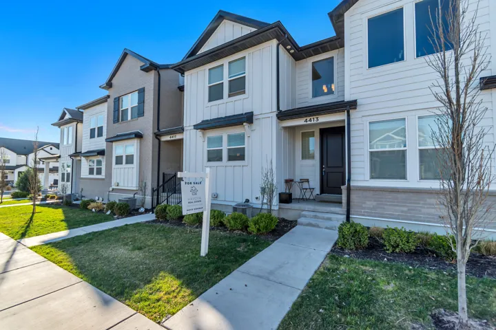 View of front of home featuring board and batten siding, a residential view, and a front yard