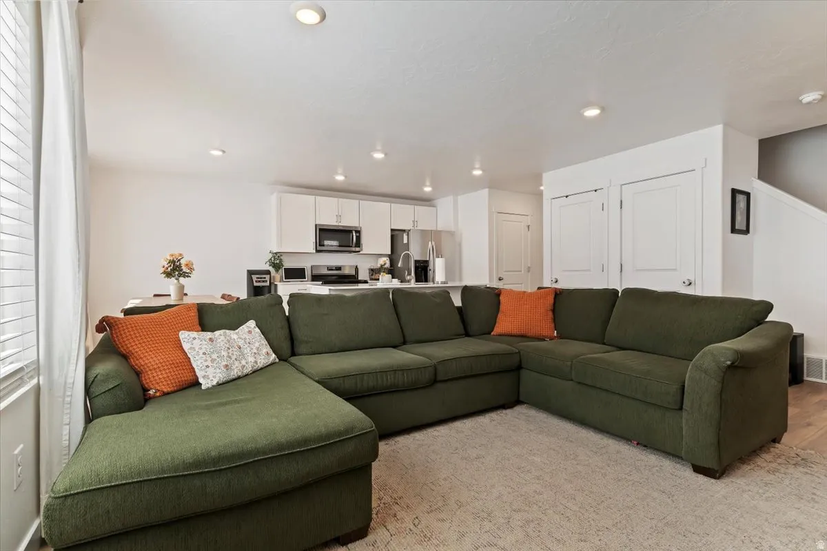 Living room featuring light wood-type flooring and recessed lighting