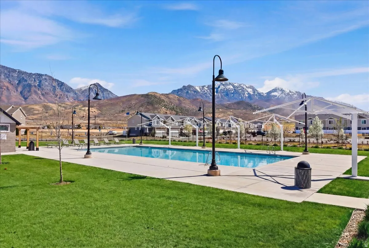 View of pool featuring patio surround, a yard, a mountain view, a residential view, and a pergola