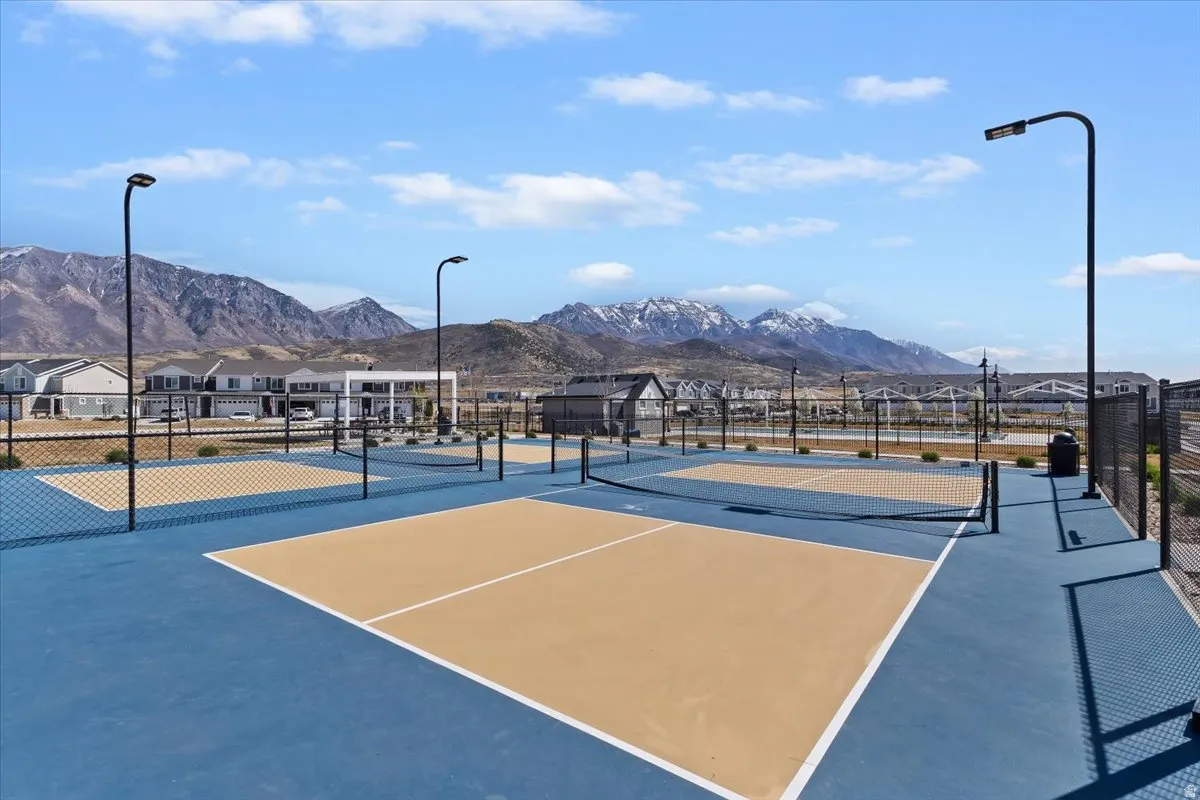View of tennis court with a mountain view