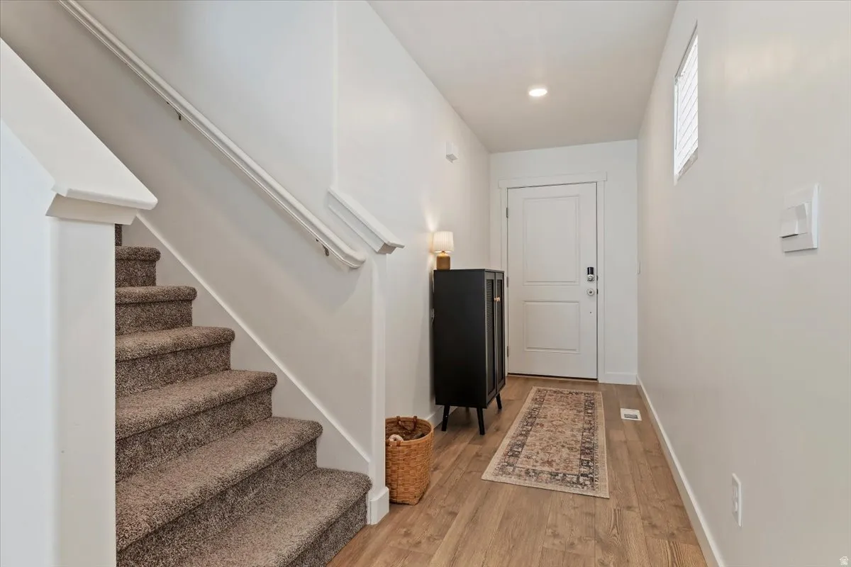 Foyer entrance featuring light wood-style floors and recessed lighting