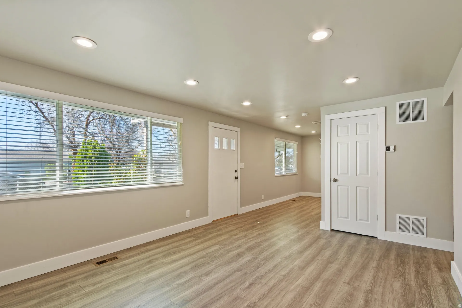 Entrance foyer with light wood finished floors and recessed lighting