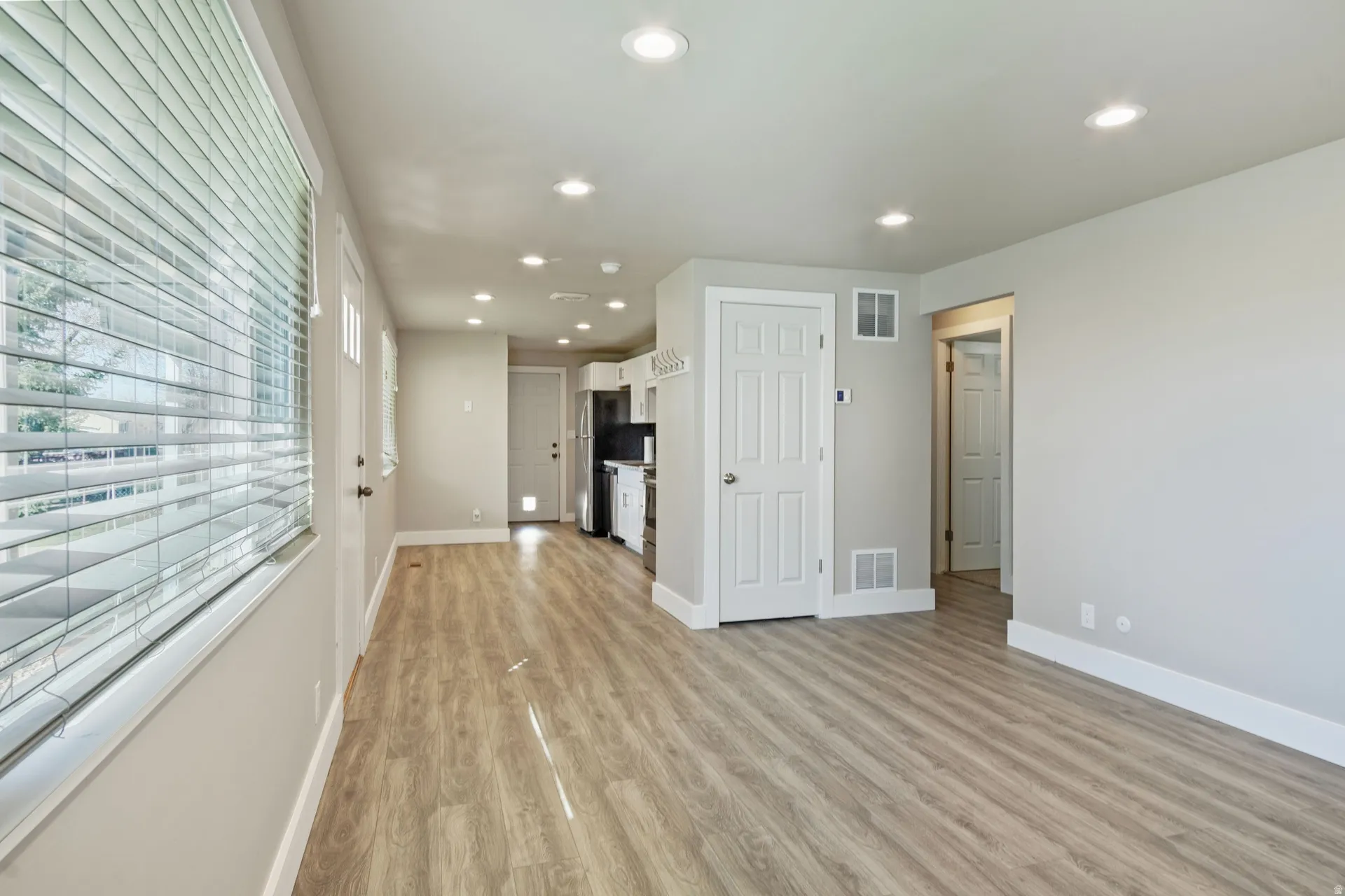 Unfurnished living room featuring recessed lighting and light wood-style floors