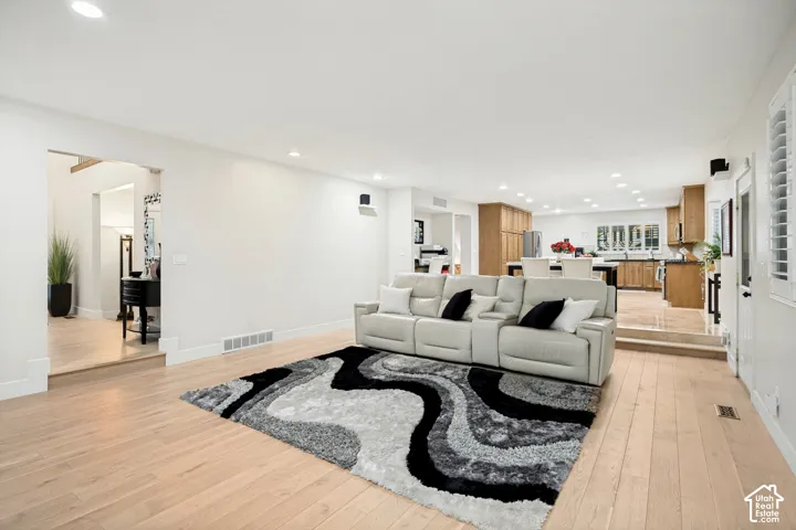 Open-concept living area featuring hardwood flooring and recessed lighting