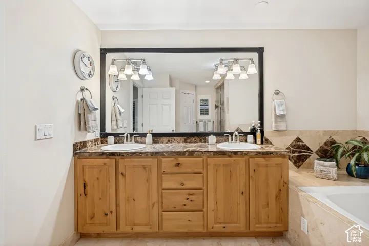 Primary ensuite with granite countertops, and a Travertine tile