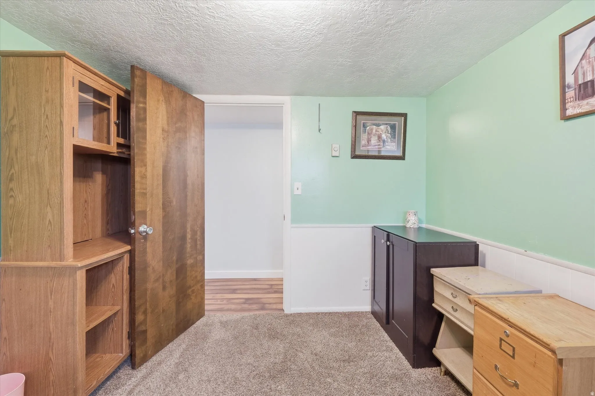 Bedroom 2 in basement with a textured ceiling and light colored carpet