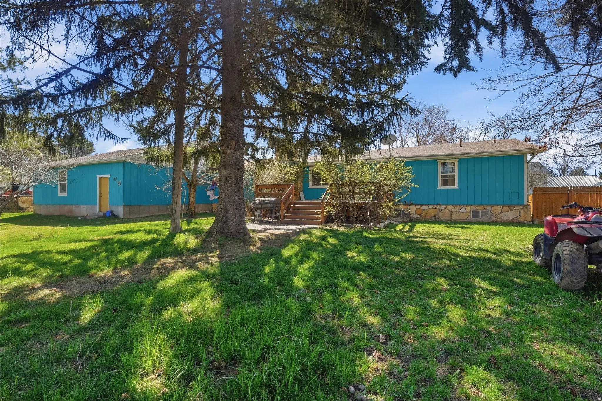 Rear view of house featuring a deck with stairs and crawl space