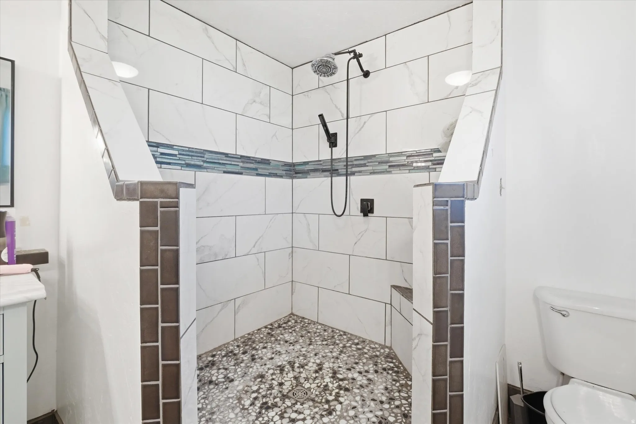 Bathroom featuring walk in shower and vanity