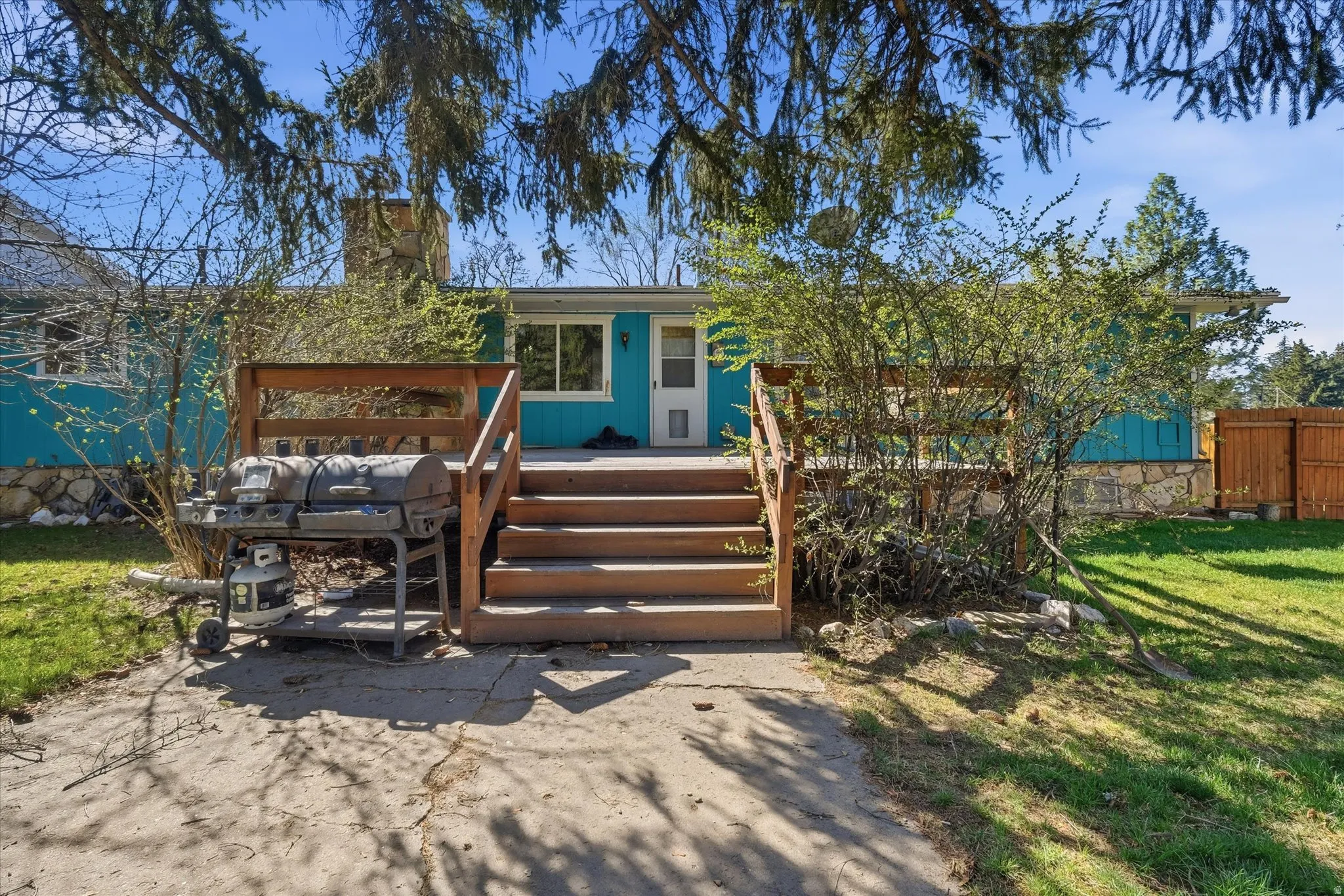 Closer view of back wooden deck with wooden stairs
