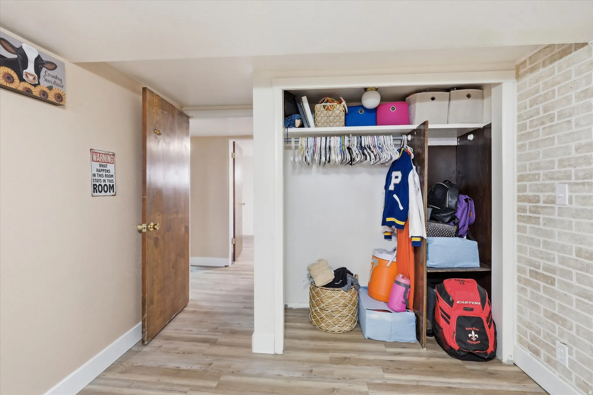 Bedroom 4 in basement  with view of closet.  Light wood-type flooring and baseboards