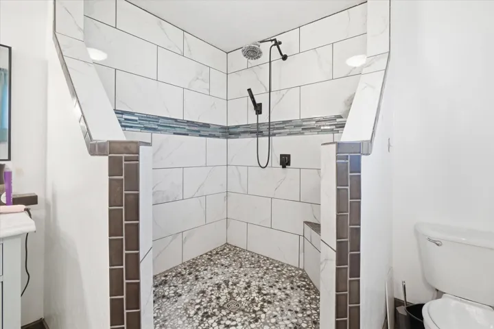 Bathroom featuring walk in shower and vanity