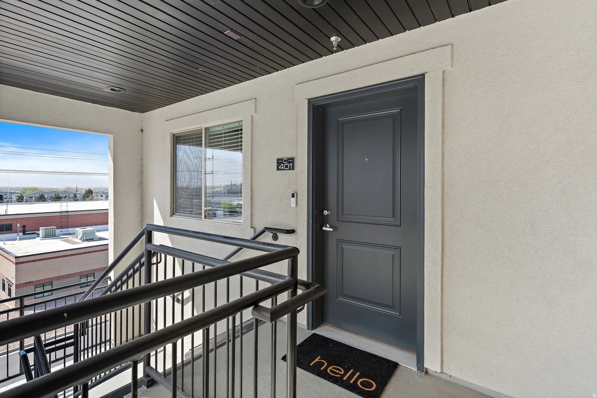Doorway to property featuring stucco siding