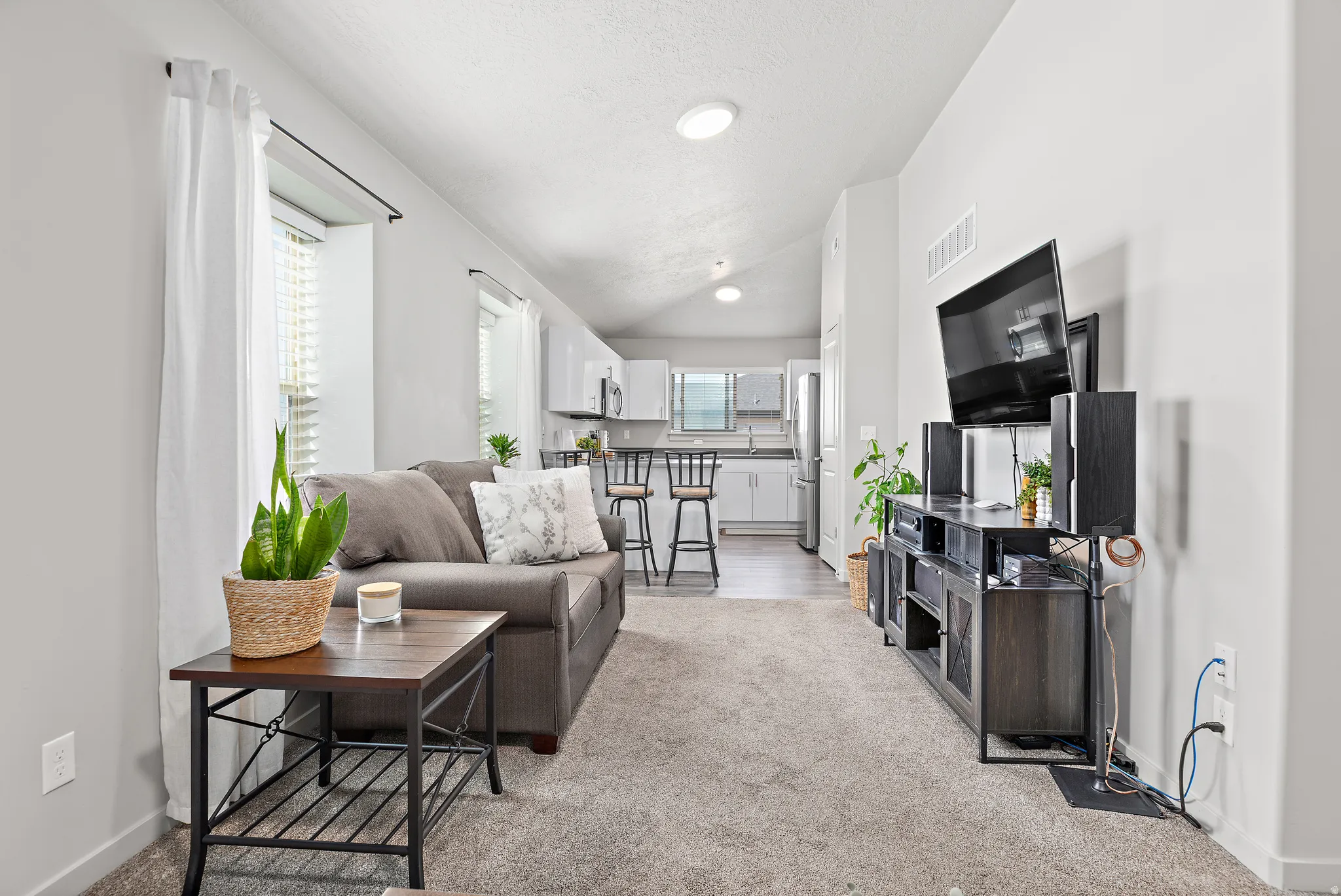 Living room featuring light colored carpet and baseboards